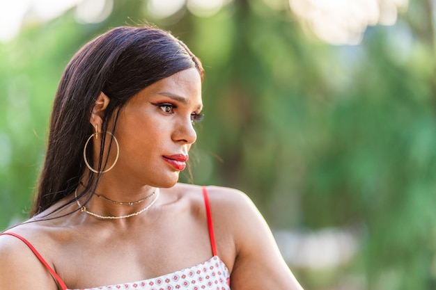 Transgender woman looking aside with worried expression outdoors