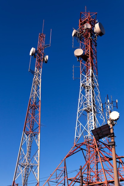 Transmission and telecommunications towers with blue sky in the background