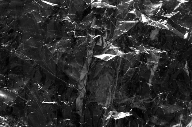 Transparante plastic zak film wrap overlay textuur op zwarte achtergrond
