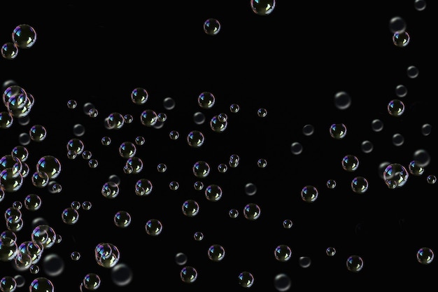 Photo transparency soap bubbles on a dark black background