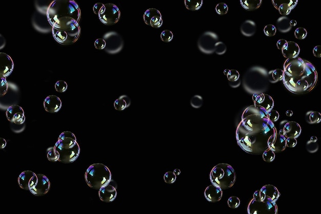 Photo transparency soap bubbles on a dark black background.