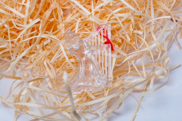 Transparent angel for Christmas decoration on a straw background in Rio de Janeiro.