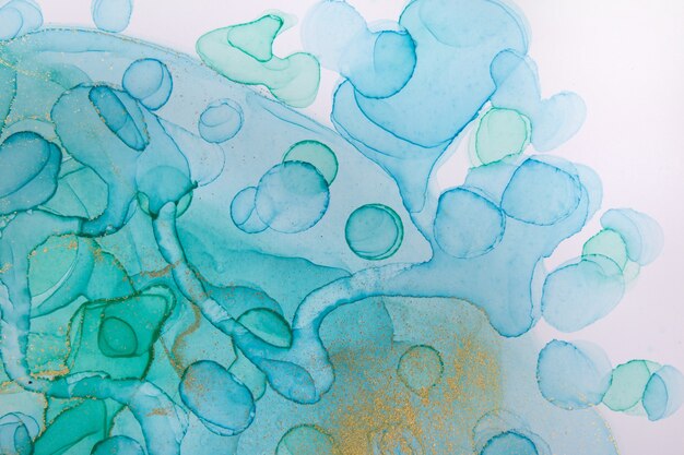 Transparent blue and gold watercolor drops on white background. Bubbles imitation.