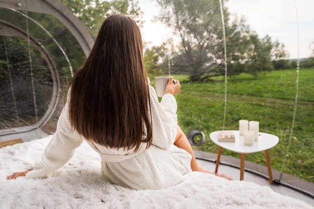 Transparent bubble tent and woman at glamping