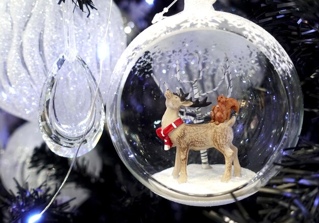 Transparent Christmas ball with a figure of a deer