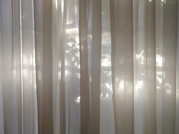 Transparent curtain with sunlight in the background