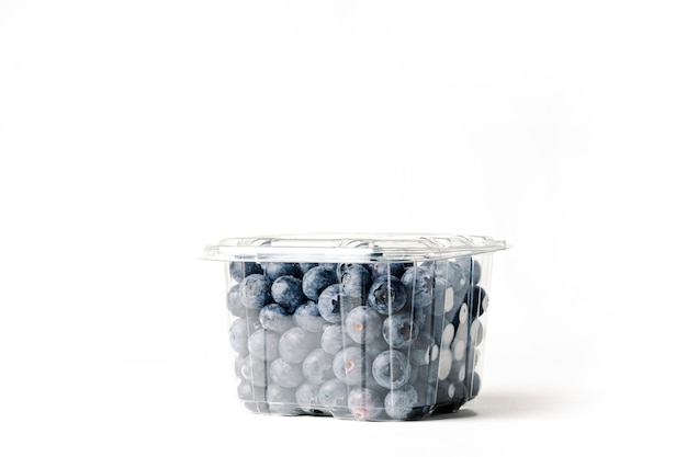 Transparent jar of blueberries, on white background, with closed lid, side view