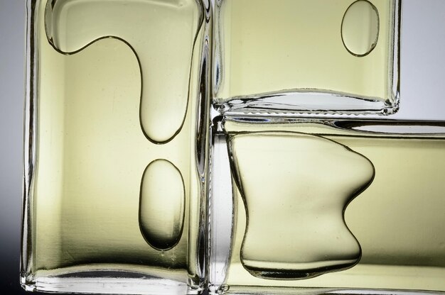 Transparent jars with perfume lie on a light background Closeup