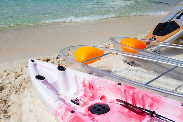 Transparent kayak canoe on the beach