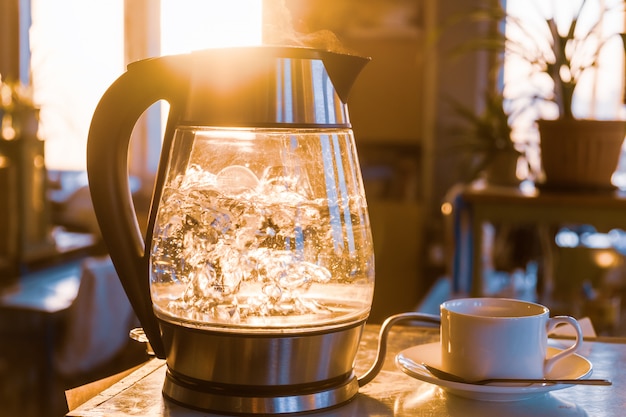 Transparent kettle with water boils