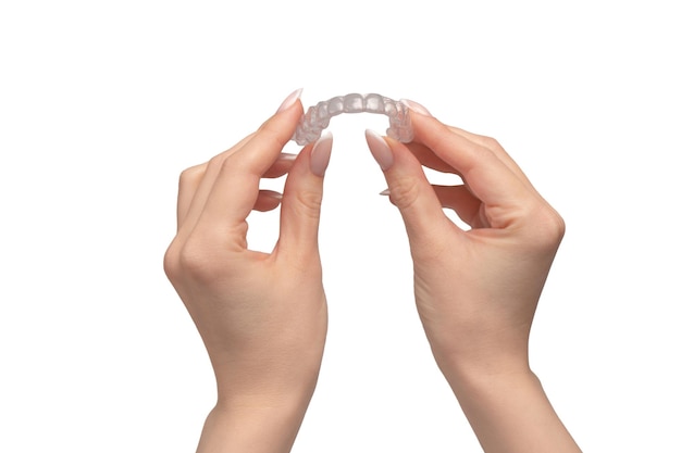 Transparent mouth guard in a womans hand isolated