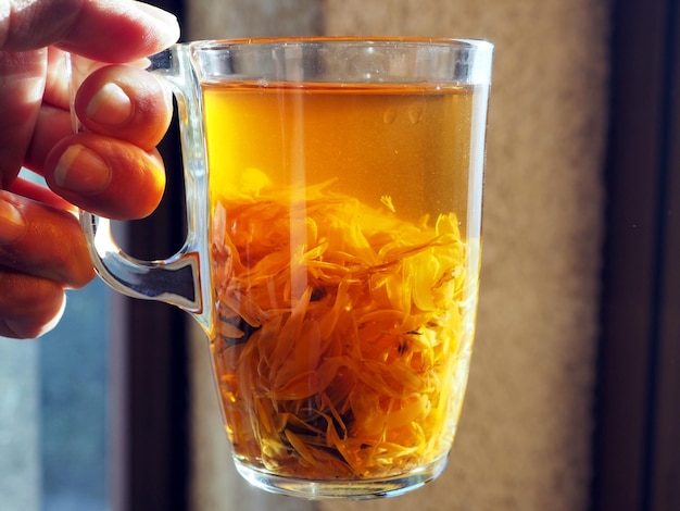 Transparent mug with calendula infusion