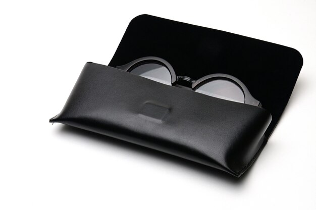 Transparent optical glasses with an eyeglass case on an isolated white background