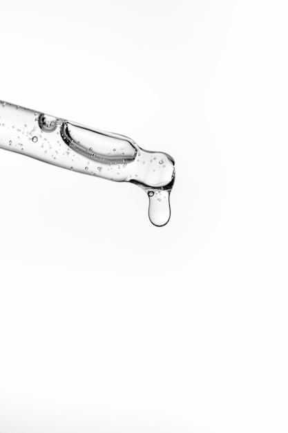 Transparent pipette with cosmetics on a white isolated background