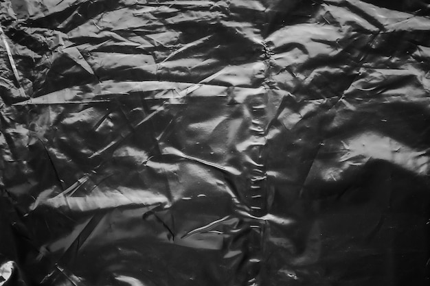 Foto texture di rivestimento di sacchetto di plastica trasparente su sfondo nero