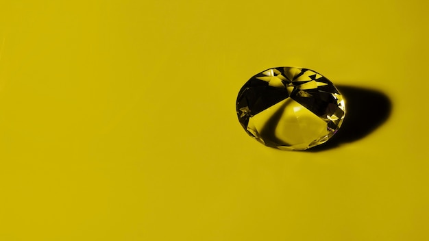 Photo transparent round diamond on ochre background