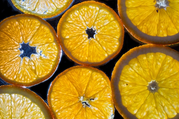 Transparent slices of oranges and lemons on the glass