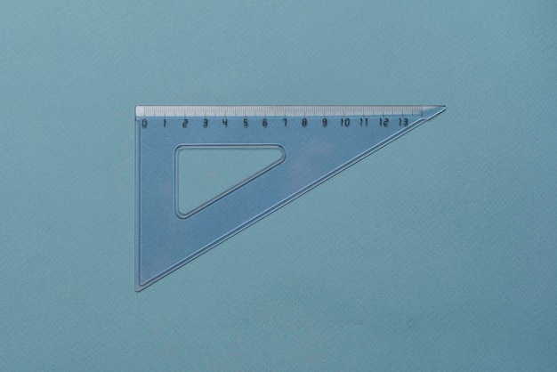 Photo a transparent square triangle ruler on pastel background school supplies