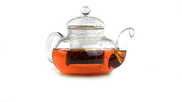 Transparent teapot with tea isolated.