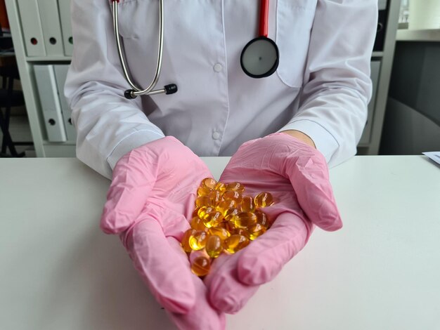 Transparent vitamins in hands of doctor vitamin omega3