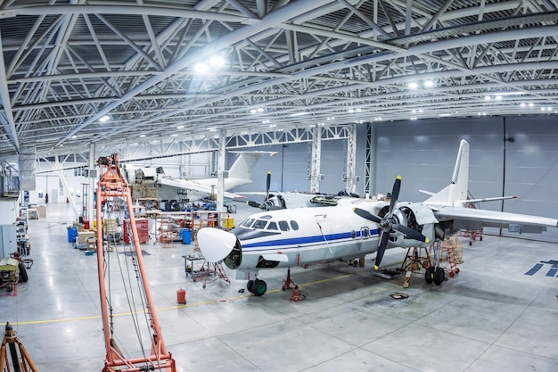 Transport aircrafts in the hangar Airplanes under maintenance Checking mechanical systems