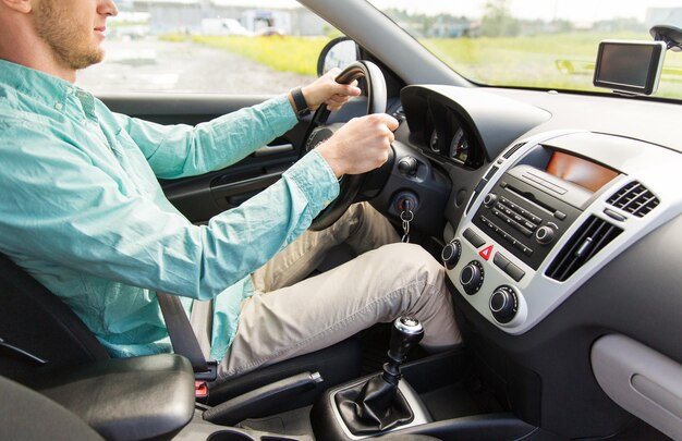 transport, business trip, destination and people concept - close up of young man driving car