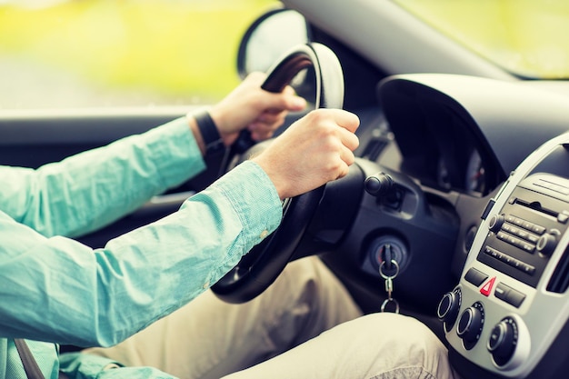 transport, business trip, destination and people concept - close up of young man driving car