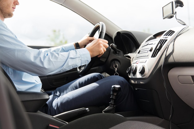 transport, business trip, destination and people concept - close up of young man in suit driving car