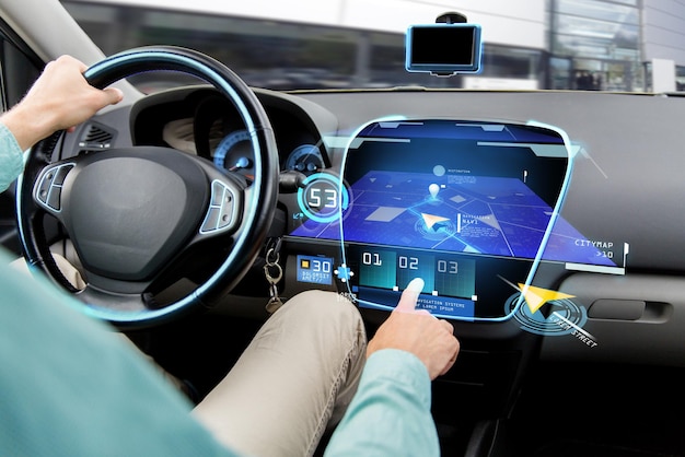 Photo transport, destination, modern technology and people concept - close up of man driving car with navigation system on board computer