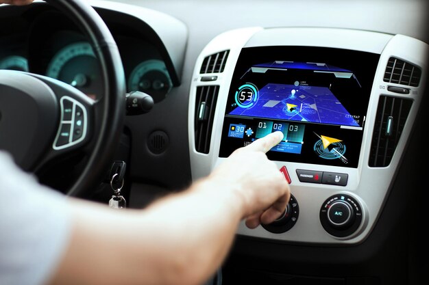 transport, destination, modern technology and people concept - male hand searching for route using navigation system on car dashboard screen