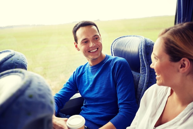 transport, tourism, road trip and people concept - group of happy passengers or tourists in travel bus