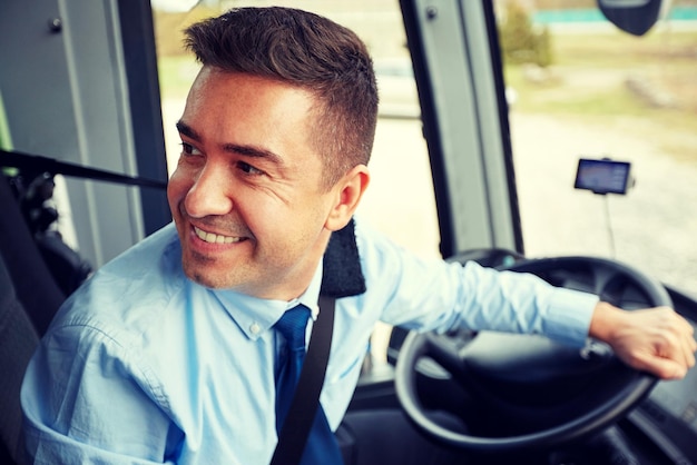 transport, tourism, road trip and people concept - happy driver driving intercity bus