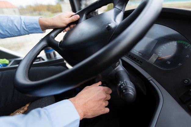 transport, transportation, tourism, road trip and people concept - close up of bus driver starting bus