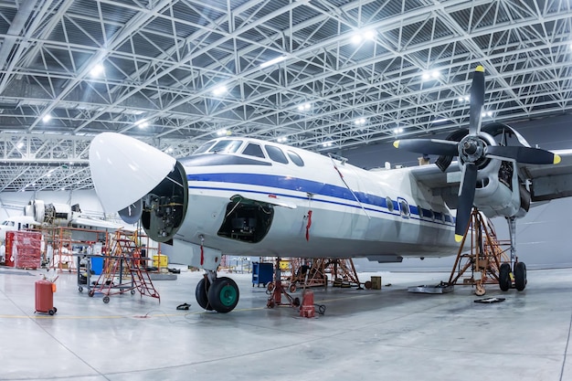 Transport turboprop aircraft in the hangar. Airplane under maintenance