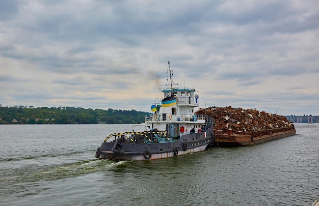 Transportation industry Ship barge transports scrap metal and sand with gravel