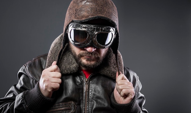 Transportation, old airplane pilot with brown leather jacket, arador hat and large glasses