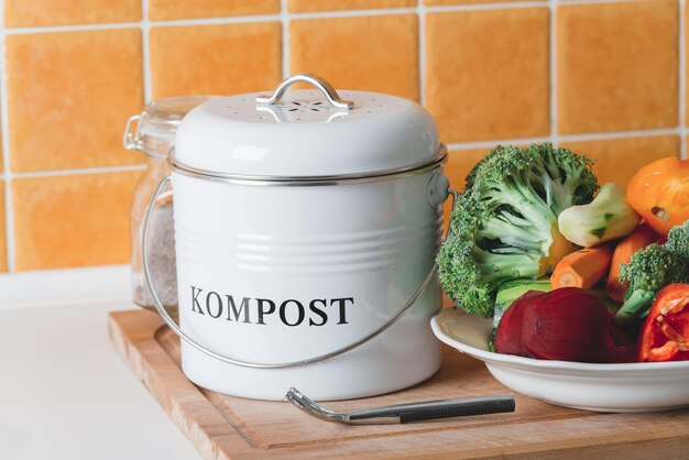 Trash bin for composting with leftover in the kitchen