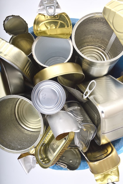 Photo trash can full of cans on white