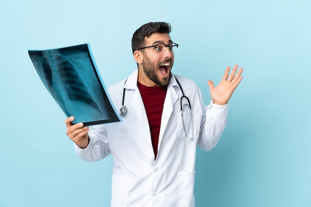traumatologist holding radiography with surprised facial expression