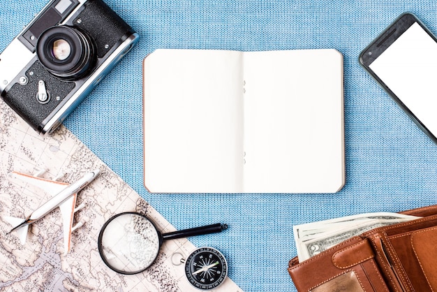 Photo travel accessories on blue knitted background, travel concept. top view