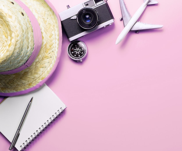 Photo travel accessories objects and gadgets top view flatlay on pink pastel