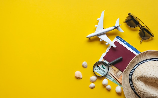 Travel accessories and objects on a yellow background