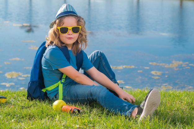 Travel and adventure concept Little child boy tourist explorer with binoculars on nature Discovery