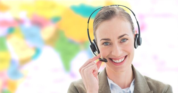 Travel agent woman wearing headset in front of world map