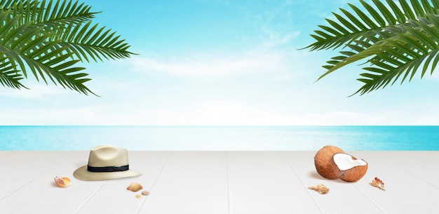 Travel background with copy space in the middle Desk with traveler hat coconuts and shells with palm leaves above