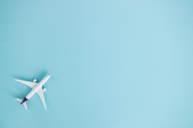 Travel concept on blue background with copy space Airplane toy on blue color background