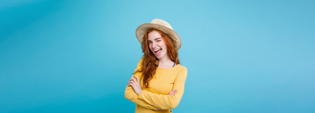 Travel concept close up portrait young beautiful attractive redhair girl wtih trendy hat and sunglas