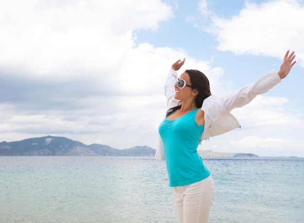 Travel concept happy girl jumping on the beach summer holiday