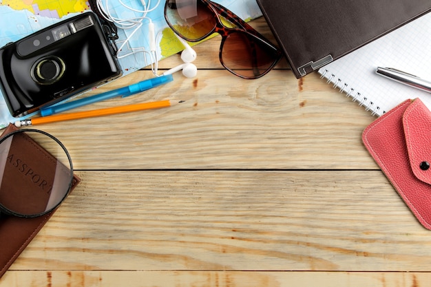 Travel concept Map, camera, passport and wallet on a natural wooden table. relaxation. holidays. top view. free space