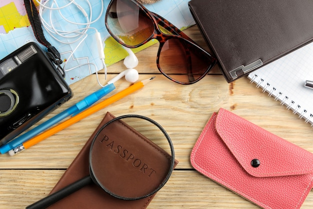 Travel concept Map, camera, passport and wallet on a natural wooden table. relaxation. holidays.